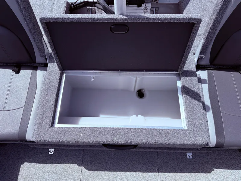 Slide: The Image of 2018 Lund 1675 Impact Sport boat storage compartment, open and empty, with gray interior. - 28