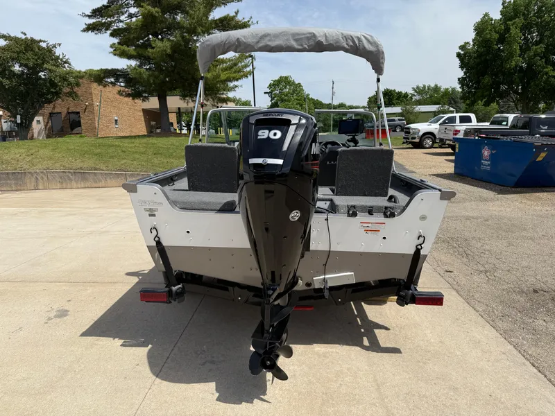 Slide: The Image of 2018 Lund 1675 Impact Sport boat with 90 HP motor, parked outdoors. - 4