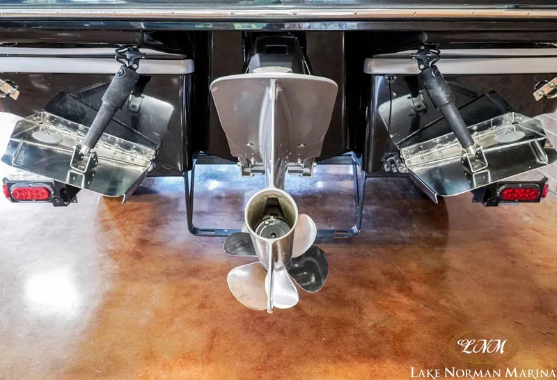 Slide: The Image of Rear view of 2016 Chaparral 227 SSX SURF boat propeller and trim tabs. - 11