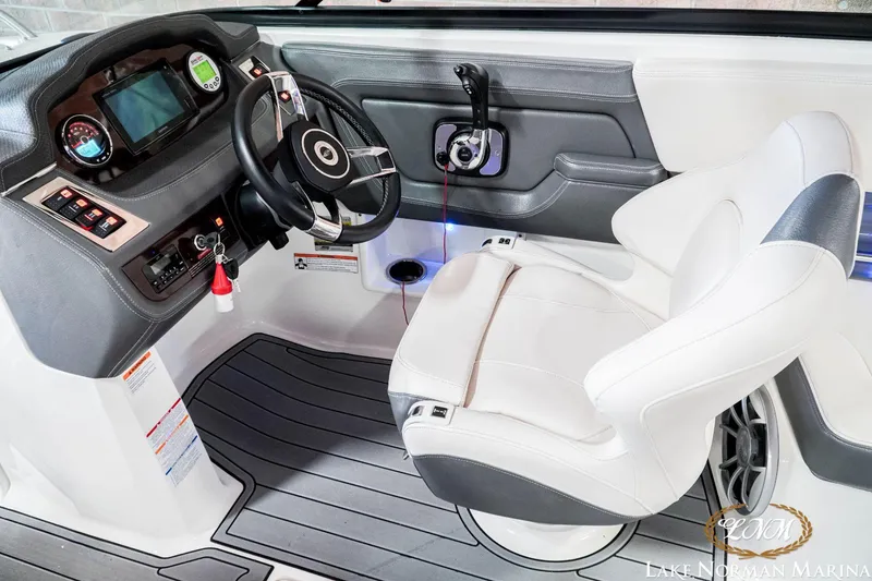 Slide: The Image of 2016 Chaparral 227 SSX SURF boat cockpit with steering wheel and control panel. - 17