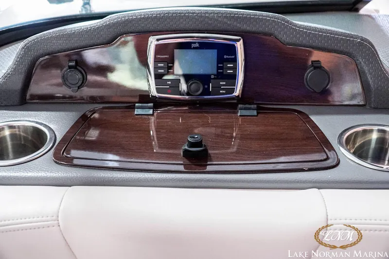 Slide: The Image of Dashboard of 2016 Chaparral 227 SSX SURF with audio controls and cup holders. - 23