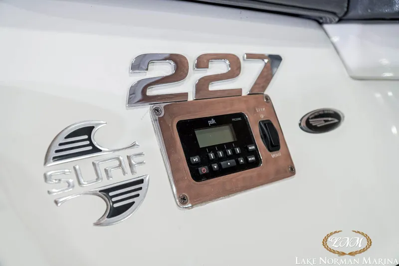 Slide: The Image of 2016 Chaparral 227 SSX SURF boat dashboard with control panel and branding. - 8