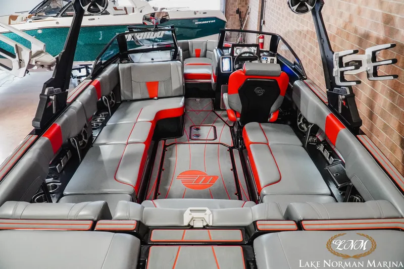 Slide: The Image of 2021 Malibu 23 LSV boat interior with gray and red seating at Lake Norman Marina. - 11