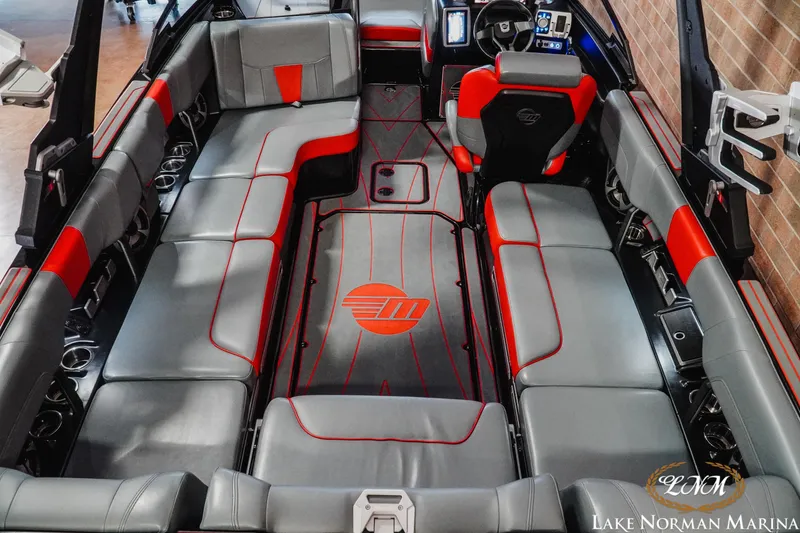 Slide: The Image of 2021 Malibu 23 LSV boat interior with gray and red seating, Lake Norman Marina. - 12