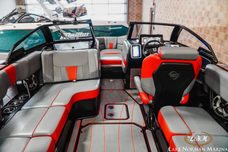 Slide: The Image of 2021 Malibu 23 LSV boat interior with red and gray seating, Lake Norman Marina. - 13