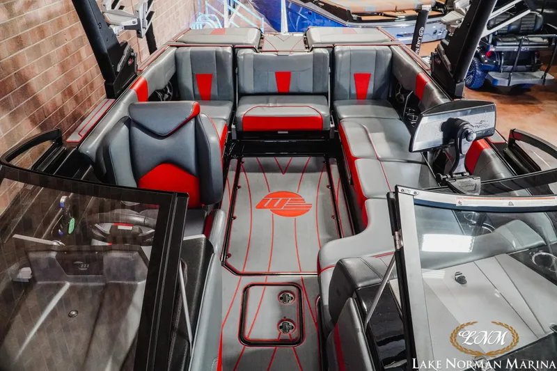 Slide: The Image of 2021 Malibu 23 LSV boat interior with red and gray seating at Lake Norman Marina. - 19