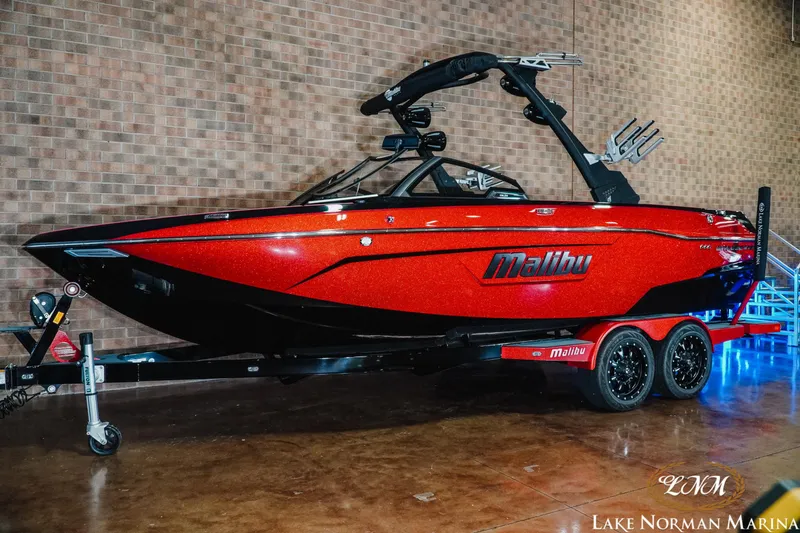 Slide: The Image of 2021 Malibu 23 LSV boat in vibrant red on display at Lake Norman Marina. - 2