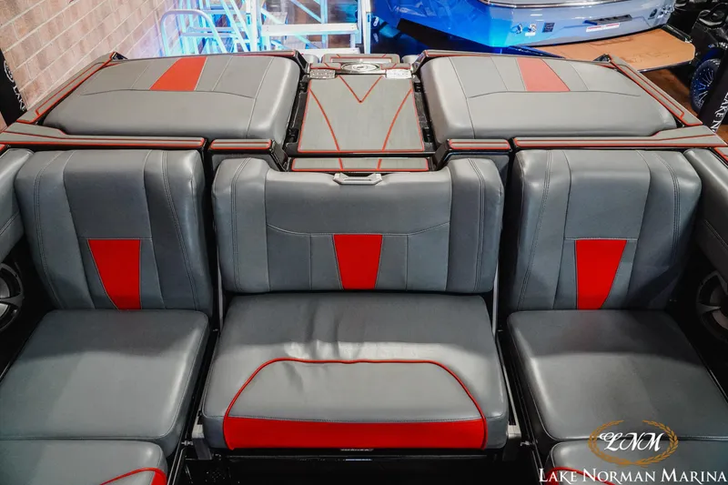 Slide: The Image of 2021 Malibu 23 LSV boat interior with gray and red seating at Lake Norman Marina. - 22