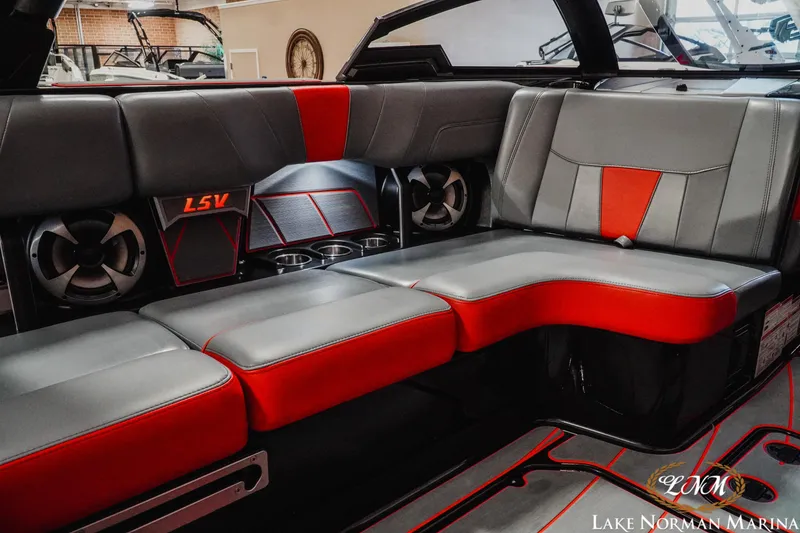 Slide: The Image of Interior of 2021 Malibu 23 LSV boat with gray and red seating at Lake Norman Marina. - 23