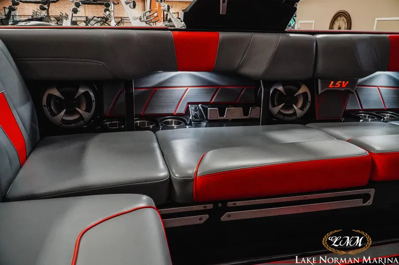Slide: The Image of Luxurious interior of 2021 Malibu 23 LSV boat with red and gray seating. - 24