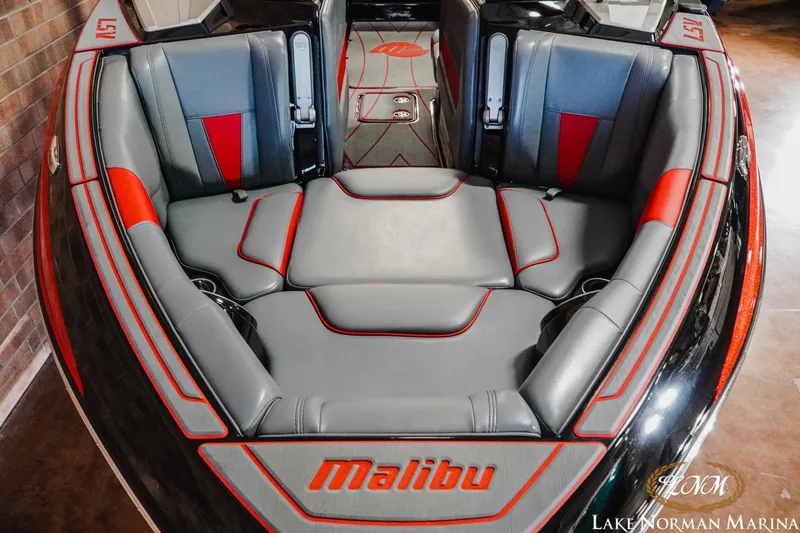Slide: The Image of 2021 Malibu 23 LSV boat interior with gray and red seating at Lake Norman Marina. - 5