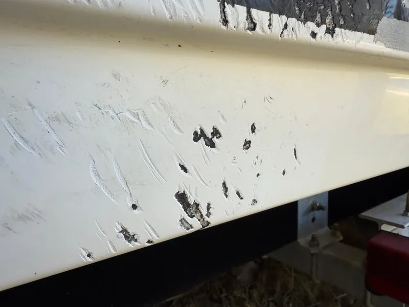 Slide: The Image of Close-up of scratches on a 2014 Sea Hunt Ultra 211 boat hull. - 11