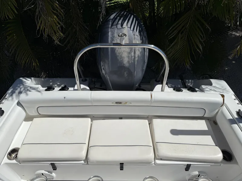 Slide: The Image of 2014 Sea Hunt Ultra 211 boat with cushioned seating and outboard motor. - 12
