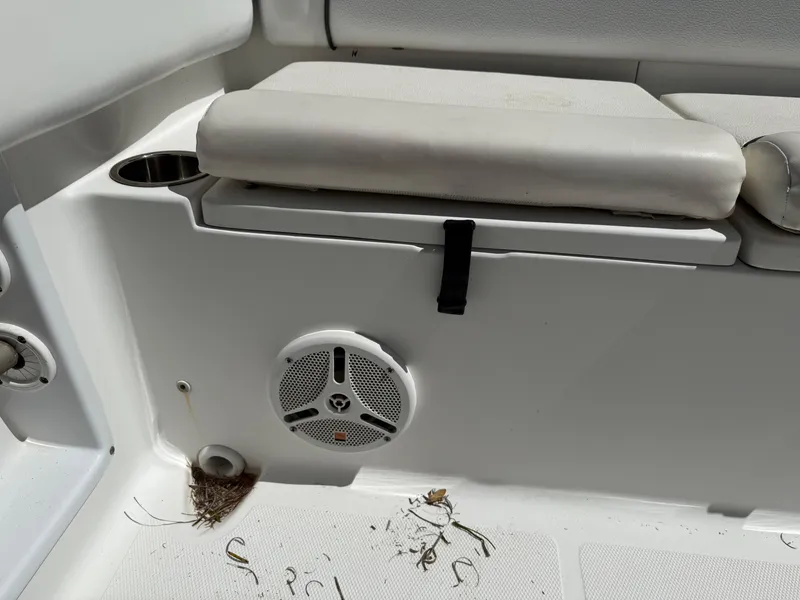 Slide: The Image of 2014 Sea Hunt Ultra 211 boat interior with speaker and cushioned seating. - 13