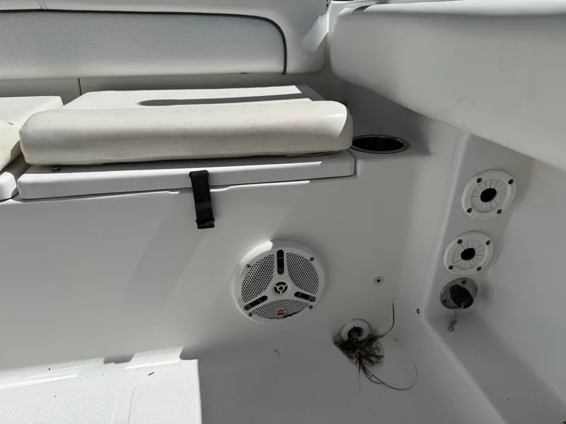 Slide: The Image of 2014 Sea Hunt Ultra 211 boat interior with seating, speaker, and cup holder. - 14