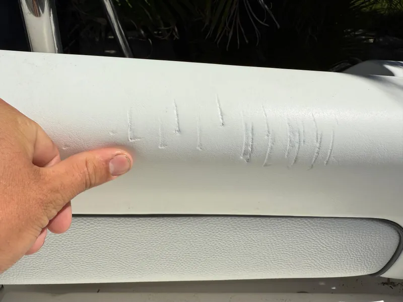 Slide: The Image of 2014 Sea Hunt Ultra 211 boat seat with visible scratches and wear. - 18