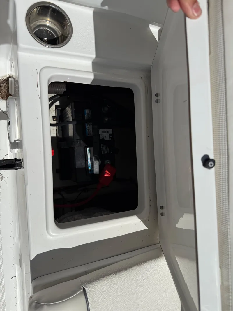 Slide: The Image of Open storage compartment on a 2014 Sea Hunt Ultra 211 boat. - 19