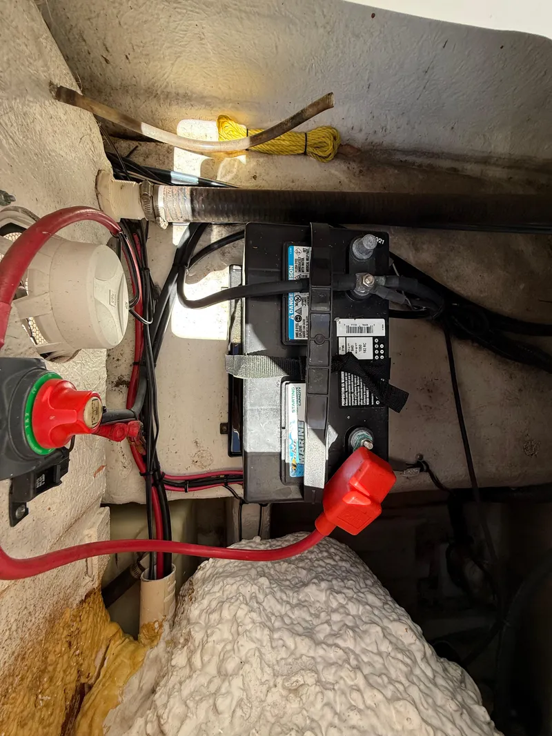 Slide: The Image of Battery compartment of a 2014 Sea Hunt Ultra 211 boat with wiring and connections. - 20