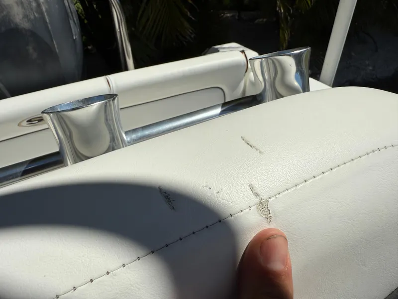 Slide: The Image of White upholstery with minor damage on a 2014 Sea Hunt Ultra 211 boat. - 27
