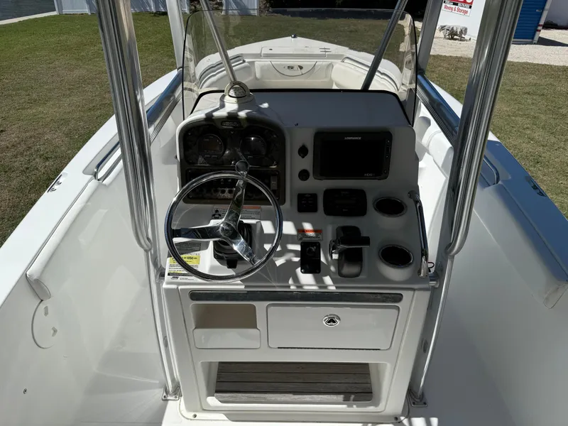 Slide: The Image of 2014 Sea Hunt Ultra 211 boat console with steering wheel and navigation controls. - 29
