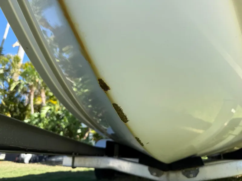 Slide: The Image of 2014 Sea Hunt Ultra 211 boat hull with visible rust and damage. - 3