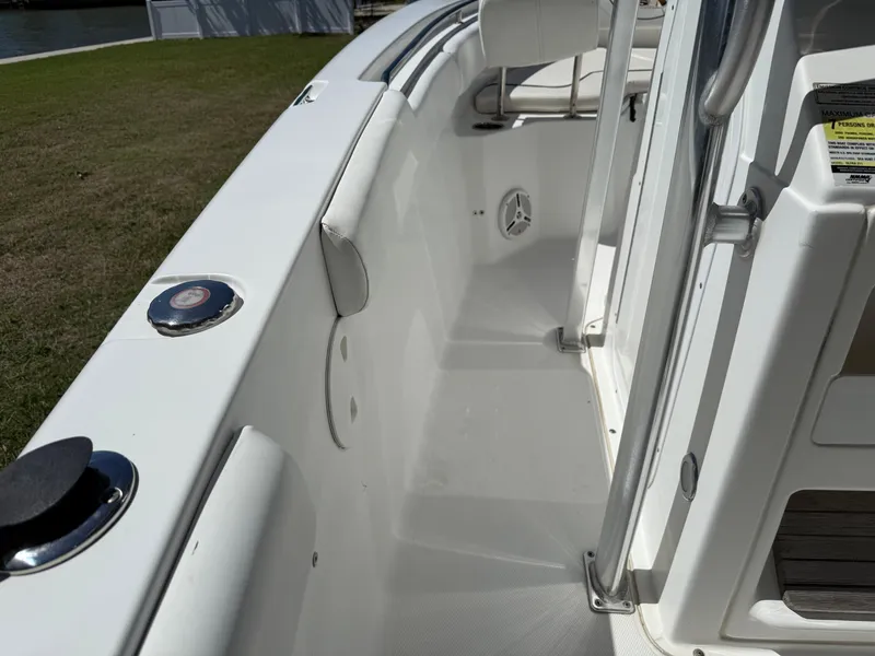 Slide: The Image of 2014 Sea Hunt Ultra 211 boat interior, featuring sleek white deck and seating area. - 30