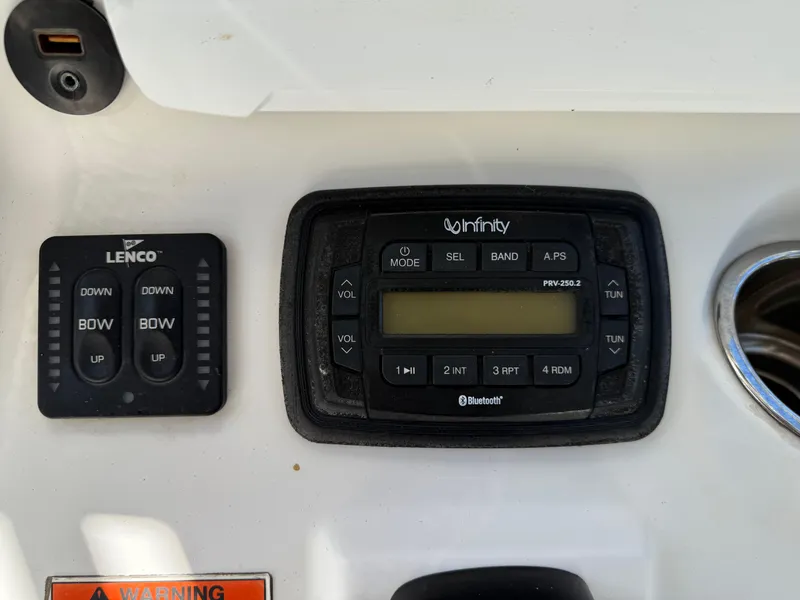 Slide: The Image of Control panel of a 2014 Sea Hunt Ultra 211 boat with Lenco and Infinity systems. - 36