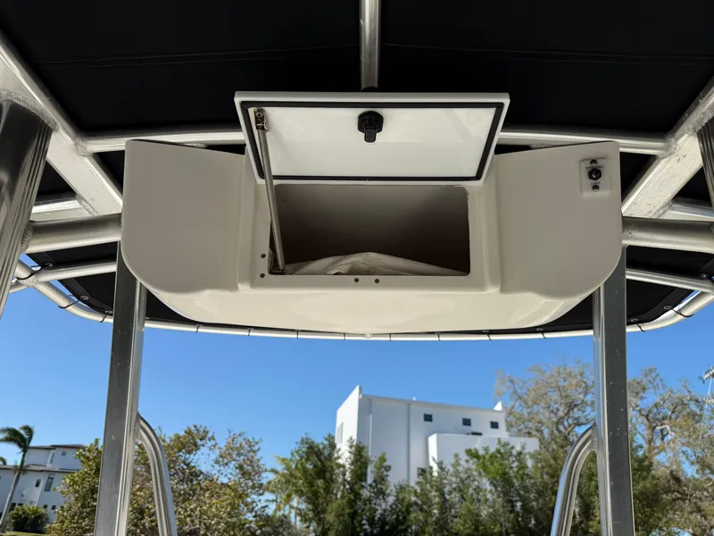 Slide: The Image of 2014 Sea Hunt Ultra 211 boat with open storage compartment under T-top. - 37