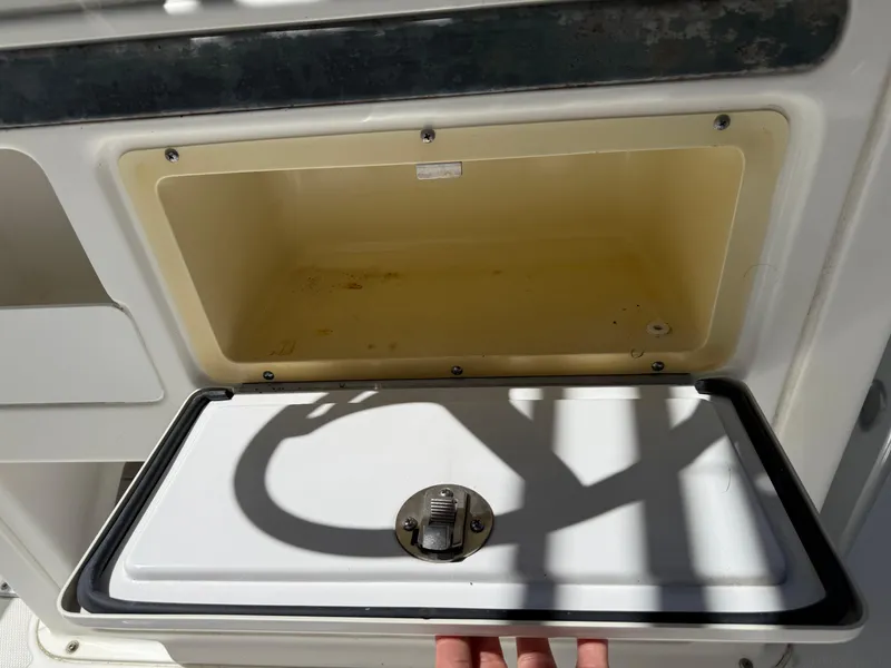Slide: The Image of Open storage compartment on 2014 Sea Hunt Ultra 211 boat. - 38