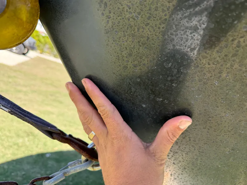 Slide: The Image of Hand touching the hull of a 2014 Sea Hunt Ultra 211 boat. - 5