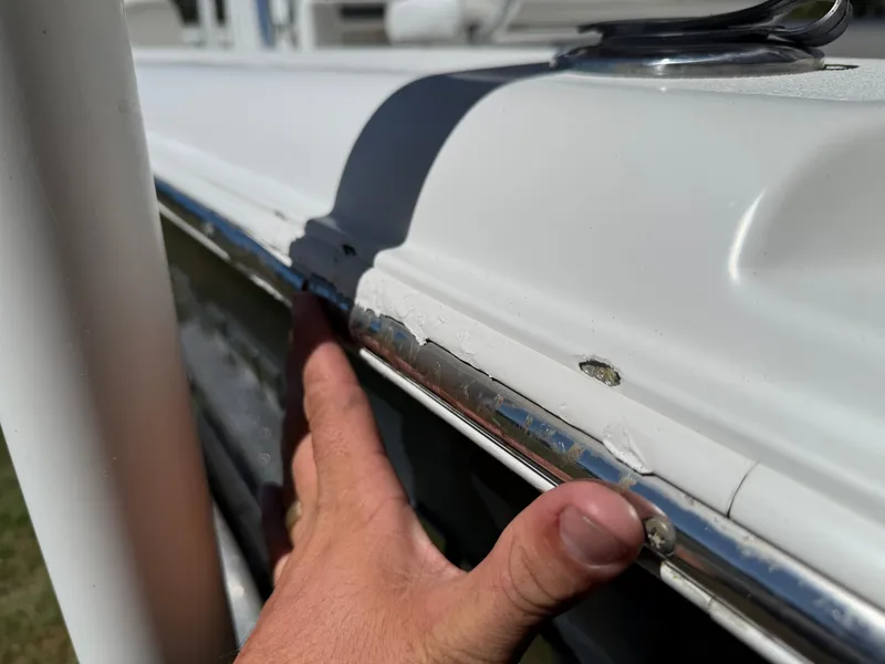 Slide: The Image of Close-up of 2014 Sea Hunt Ultra 211 boat with visible damage on the railing. - 7