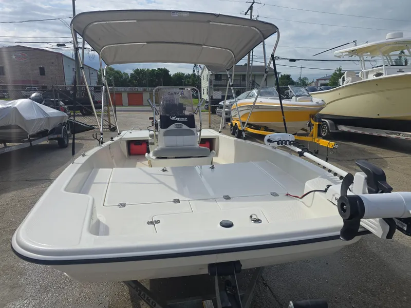 Slide: The Image of 2019 Mako Pro Skiff 17 CC boat with canopy in a marina setting. - 3