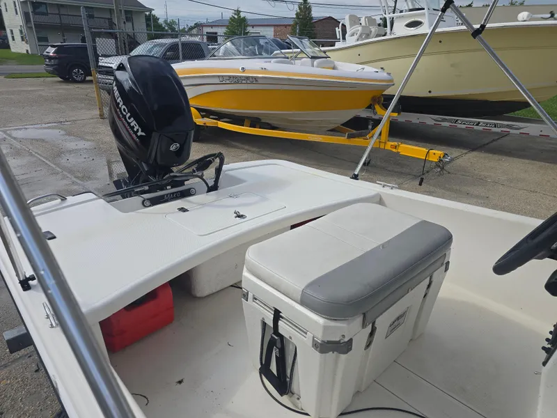 Slide: The Image of 2019 Mako Pro Skiff 17 CC boat interior with Mercury engine and cooler seat. - 4