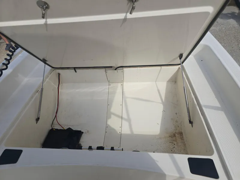 Slide: The Image of Open storage compartment of 2019 Mako Pro Skiff 17 CC boat. - 7