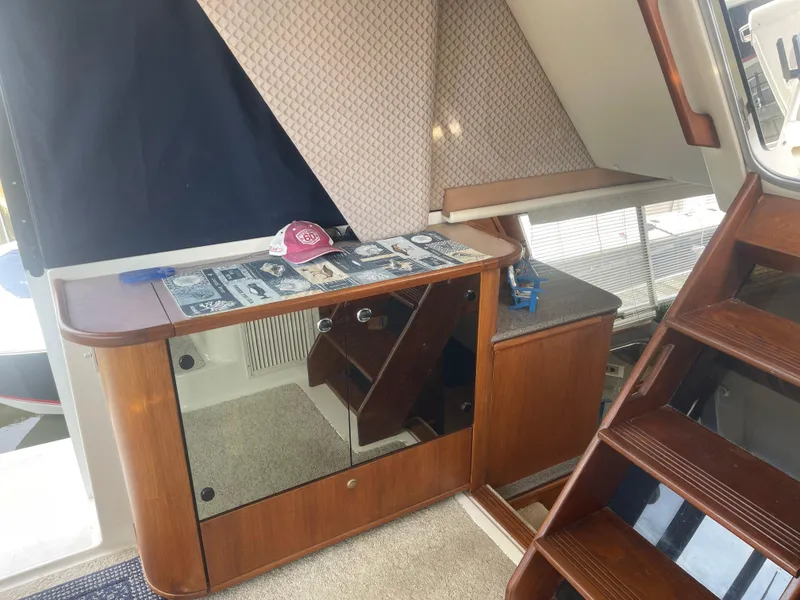 Slide: The Image of Interior of 1999 Bayliner 4788 Motoryacht with wooden cabinetry and stairs. - 12