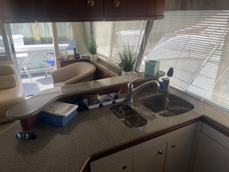 Slide: The Image of Interior of 1999 Bayliner 4788 Motoryacht with kitchen sink and seating area. - 14