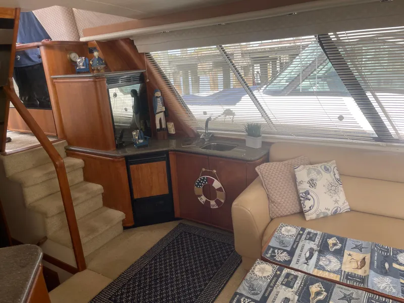 Slide: The Image of Interior of 1999 Bayliner 4788 Motoryacht with cozy seating and nautical decor. - 16
