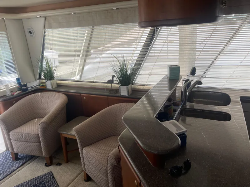 Slide: The Image of Interior of 1999 Bayliner 4788 Motoryacht with chairs, counter, and potted plants. - 18