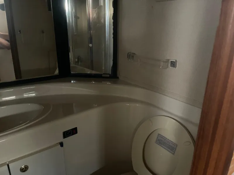 Slide: The Image of 1999 Bayliner 4788 Motoryacht bathroom with shower, sink, and toilet. - 20