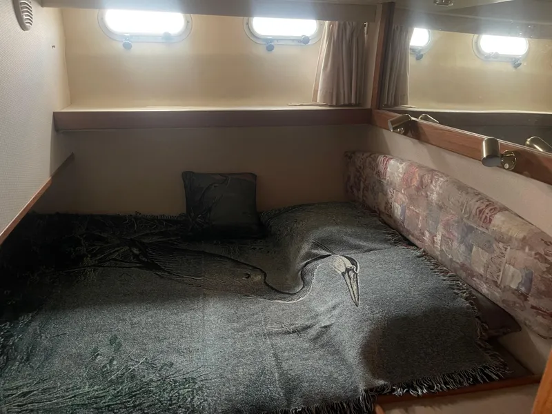 Slide: The Image of Cozy cabin interior of 1999 Bayliner 4788 Motoryacht with bed and windows. - 22