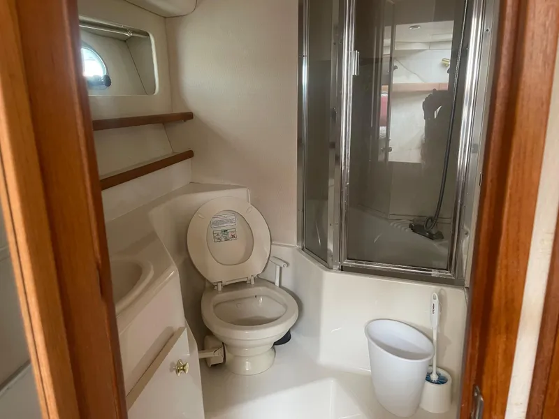 Slide: The Image of 1999 Bayliner 4788 Motoryacht bathroom with toilet, shower, and sink. - 26