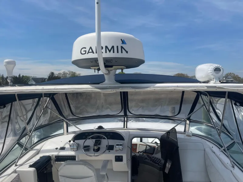Slide: The Image of 1999 Bayliner 4788 Motoryacht helm with Garmin radar, clear skies in background. - 6