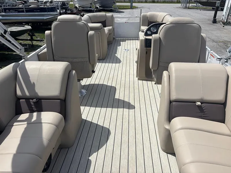 Slide: The Image of 2023 SunCatcher Fusion 22RC pontoon boat interior with beige seating and spacious layout. - 10