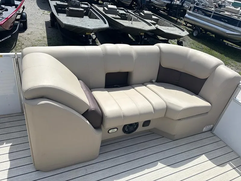 Slide: The Image of 2023 SunCatcher Fusion 22RC boat seating, beige upholstery, outdoor setting. - 11