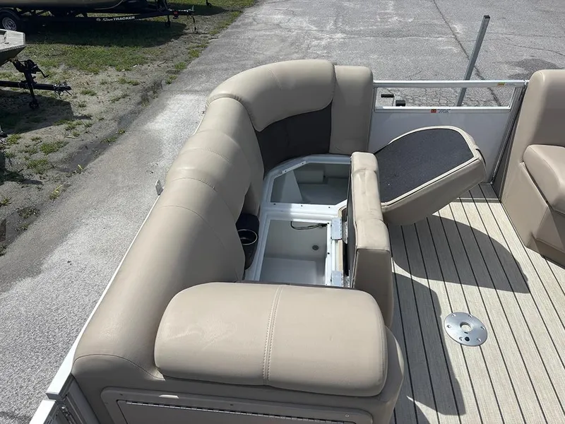 Slide: The Image of 2023 SunCatcher Fusion 22RC boat with beige seating and storage compartment open. - 12