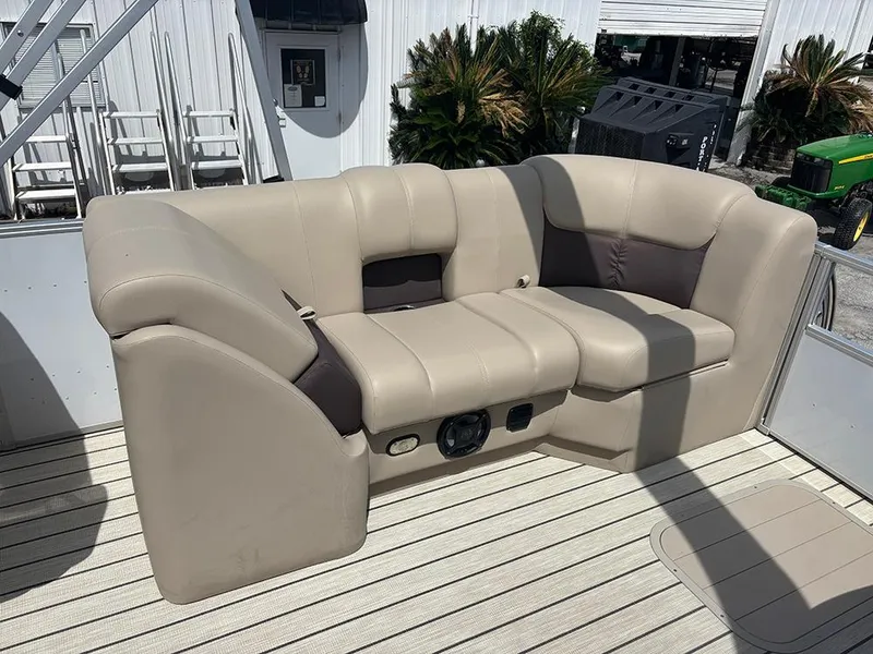 Slide: The Image of 2023 SunCatcher Fusion 22RC boat seating, beige upholstery, outdoor setting. - 19