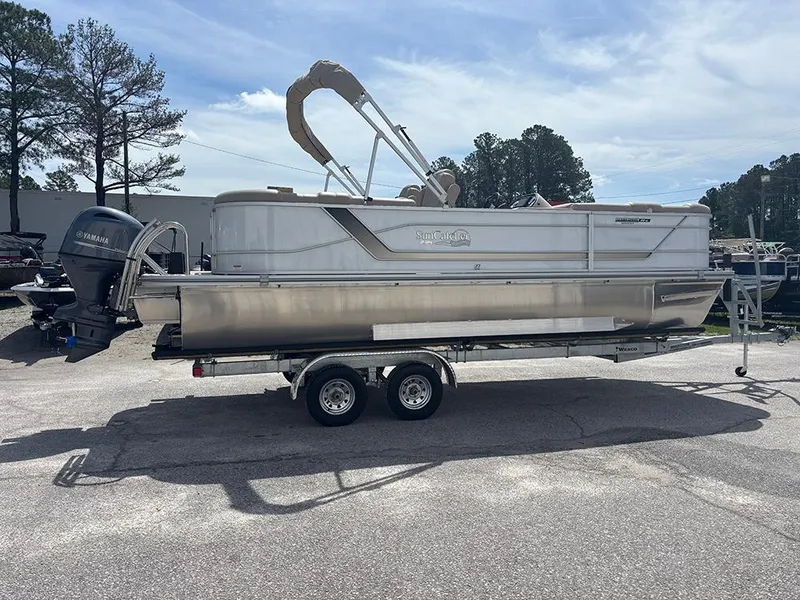 Slide: The Image of 2023 SunCatcher Fusion 22RC pontoon boat on trailer, parked outdoors. - 4