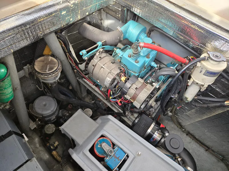 Slide: The Image of Engine compartment of a 1985 Amel Maramu sailboat, showcasing mechanical components and wiring. - 16