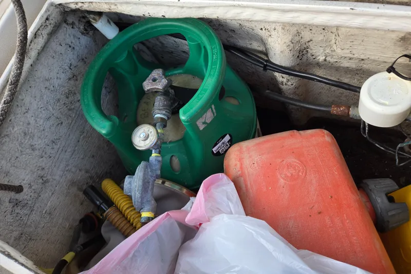 Slide: The Image of Storage compartment with gas cylinder and container on 1985 Amel Maramu boat. - 18