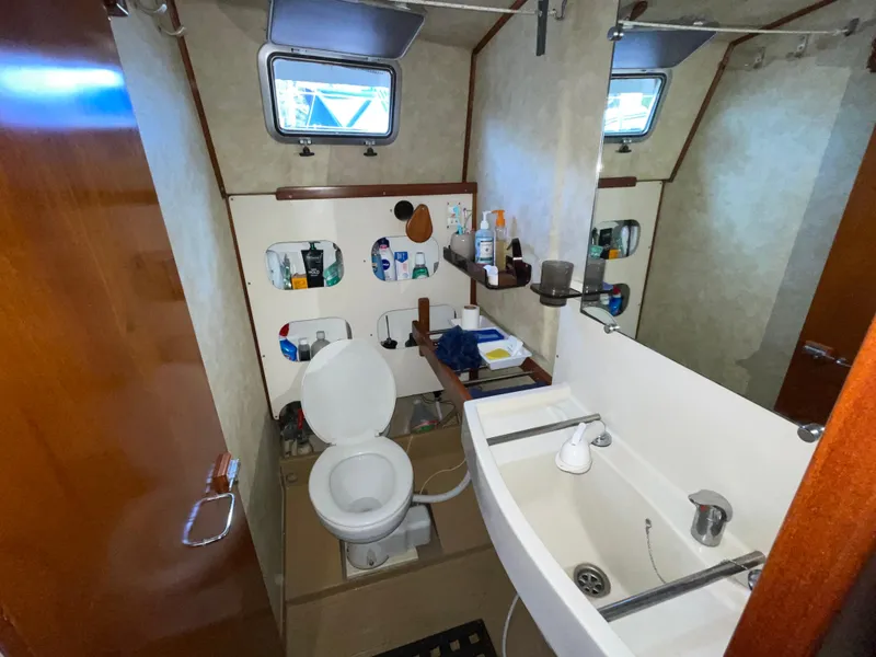 Slide: The Image of Bathroom interior of 1985 Amel Maramu yacht with sink, toilet, and storage shelves. - 38